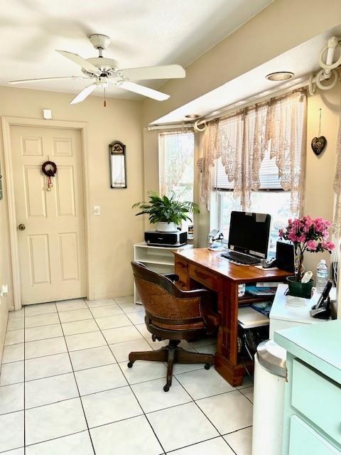 office area with a ceiling fan and light tile patterned floors