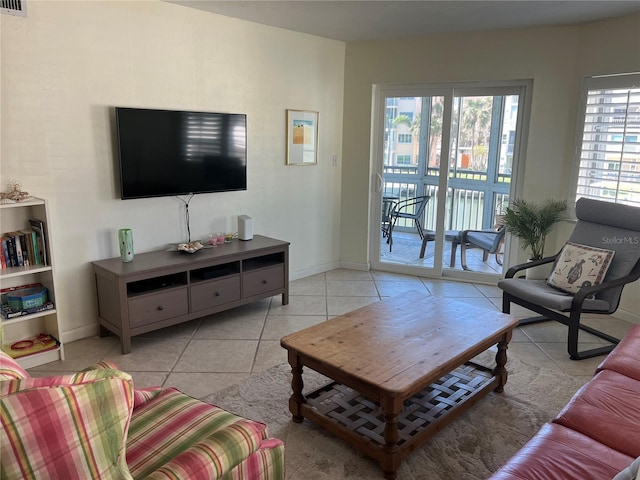 living area featuring light tile patterned floors and baseboards