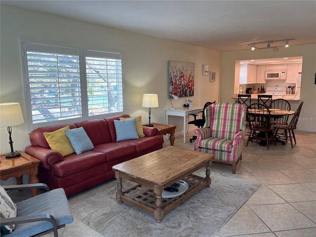 living room with light tile patterned flooring and track lighting