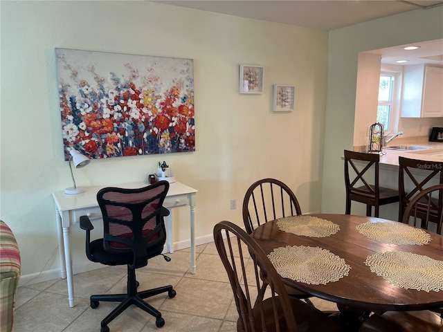 dining space featuring light tile patterned floors and baseboards