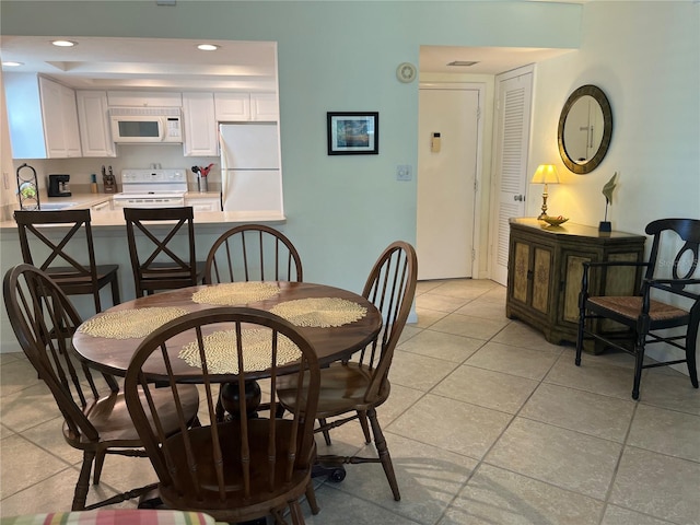 dining room with recessed lighting and light tile patterned floors