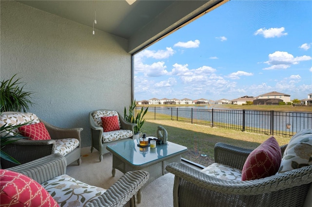 view of patio / terrace featuring a residential view, a water view, and a fenced backyard