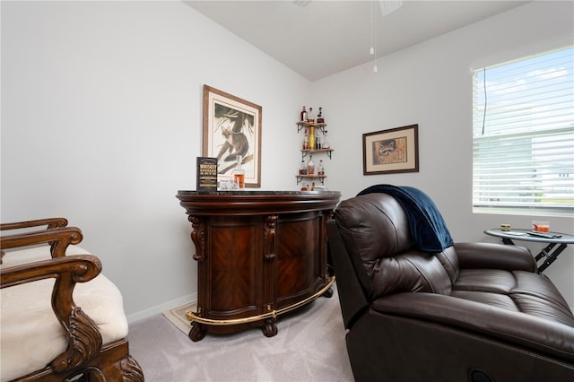 office space with baseboards, a bar, and carpet