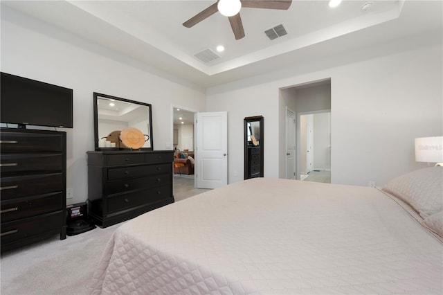 bedroom featuring visible vents, recessed lighting, light colored carpet, and a raised ceiling