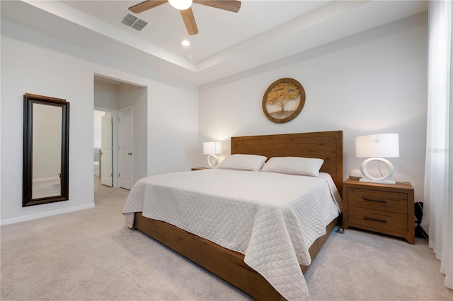 bedroom with visible vents, a tray ceiling, recessed lighting, baseboards, and light colored carpet