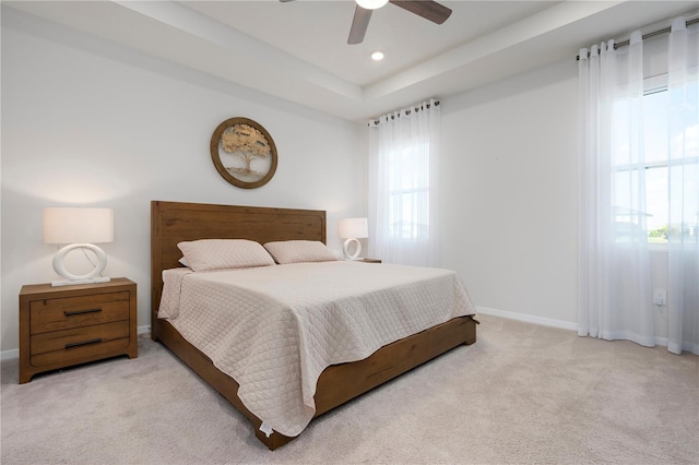 carpeted bedroom featuring recessed lighting, a ceiling fan, a raised ceiling, and baseboards