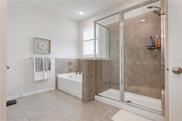 bathroom featuring tile patterned floors, baseboards, a stall shower, and a bath