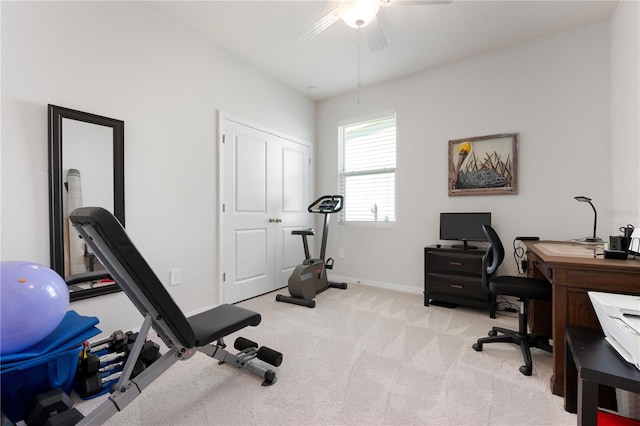 office with ceiling fan, baseboards, and light carpet