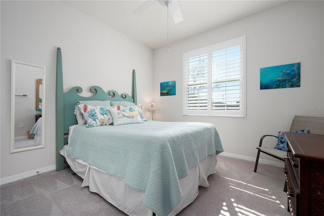 carpeted bedroom with baseboards and ceiling fan