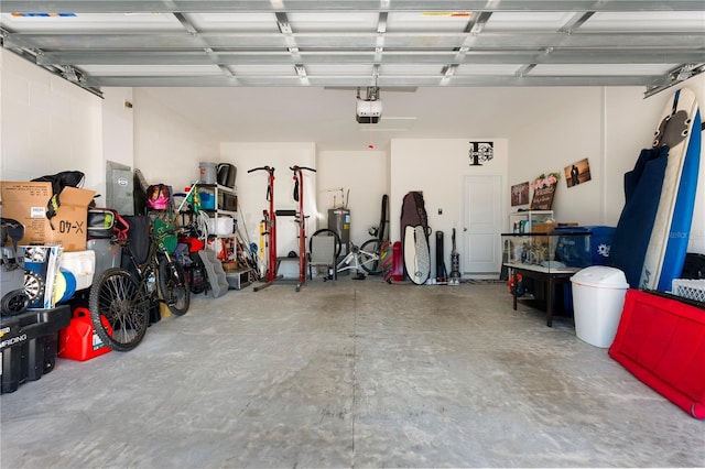 garage featuring a garage door opener and water heater