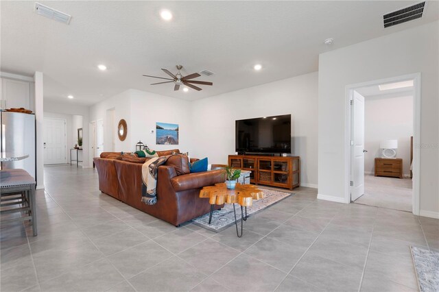 3677 Turning Tides Ter, Bradenton, FL 34208 - living room with recessed lighting, ceiling fan, light tile patterned floors, and baseboards