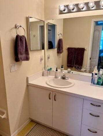 bathroom featuring baseboards and vanity