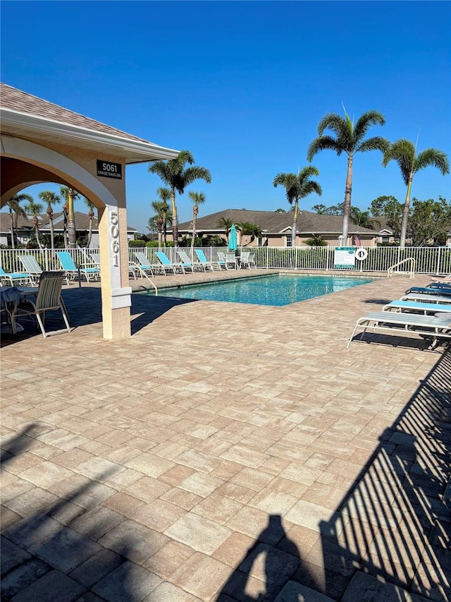 pool featuring a patio area and fence