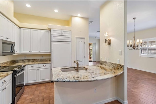 kitchen featuring stainless steel microwave, black electric range, light wood-type flooring, and white cabinets