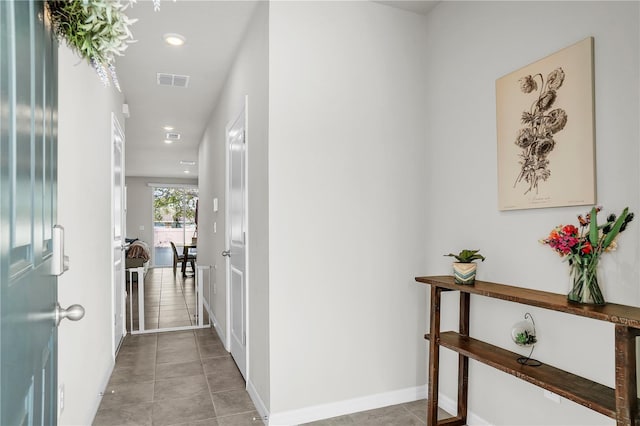 hall with recessed lighting, light tile patterned flooring, baseboards, and visible vents