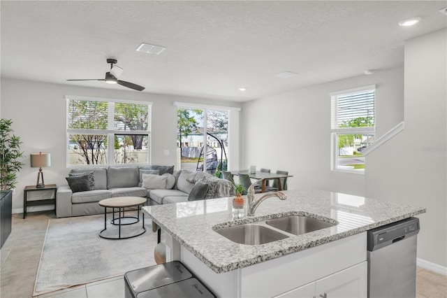 kitchen featuring a sink, visible vents, stainless steel dishwasher, and a healthy amount of sunlight