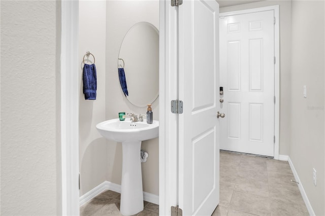 bathroom featuring tile patterned floors and baseboards