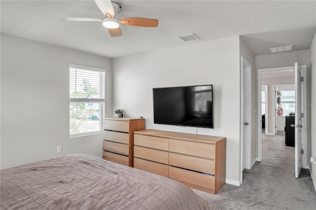 bedroom with visible vents, baseboards, carpet, and ceiling fan