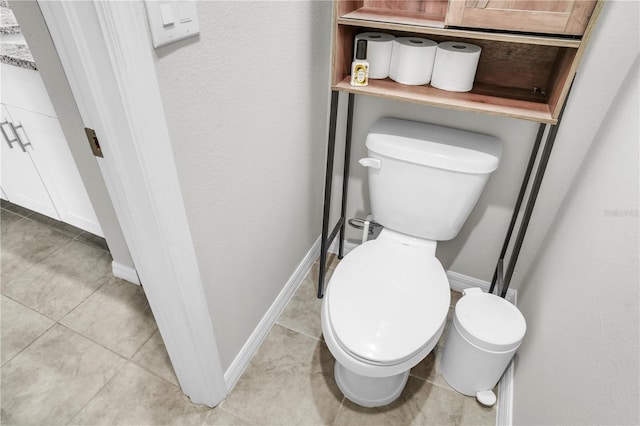 bathroom featuring tile patterned floors, toilet, and baseboards