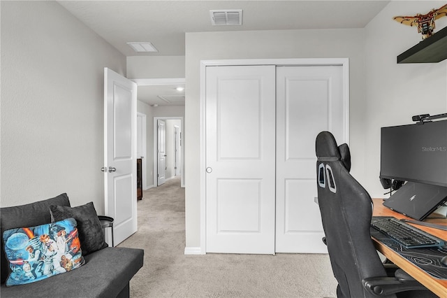 office space with visible vents, light carpet, and baseboards