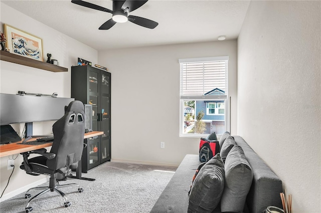 office space with carpet flooring, a ceiling fan, and baseboards