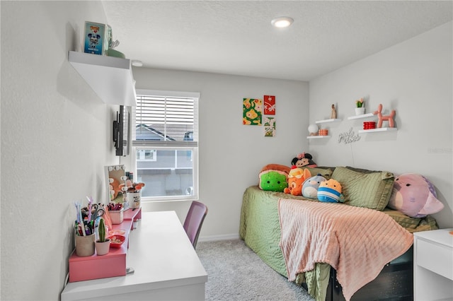 bedroom featuring baseboards, a textured ceiling, and carpet