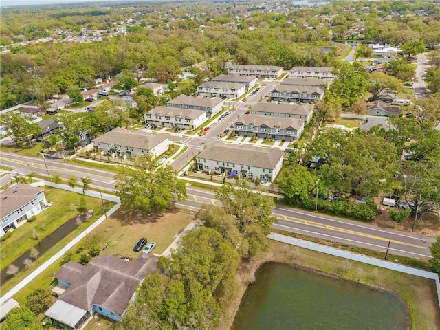 drone / aerial view featuring a residential view and a water view