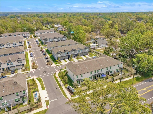 drone / aerial view with a residential view and a view of trees