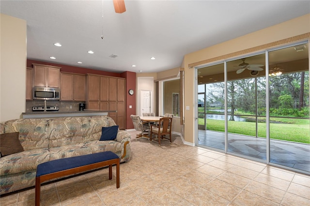 living area with recessed lighting, a healthy amount of sunlight, visible vents, and ceiling fan