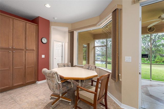 dining area with baseboards and ceiling fan