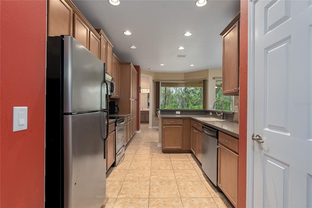 kitchen with light tile patterned flooring, recessed lighting, a sink, stainless steel appliances, and dark countertops