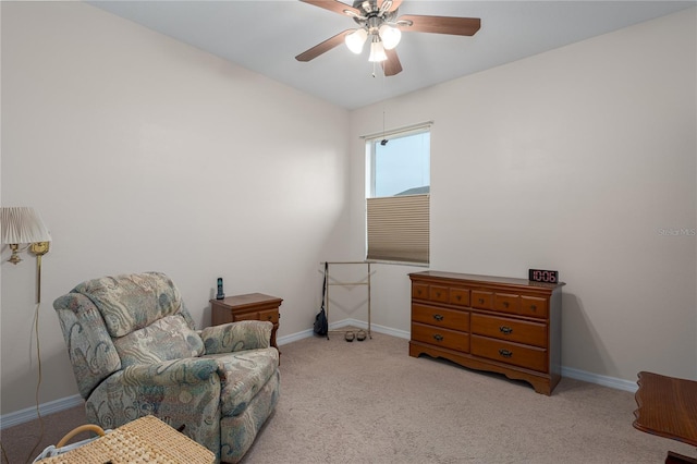 sitting room featuring a ceiling fan, baseboards, and carpet floors