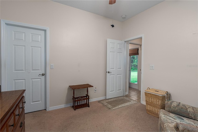 sitting room featuring carpet flooring, baseboards, and ceiling fan