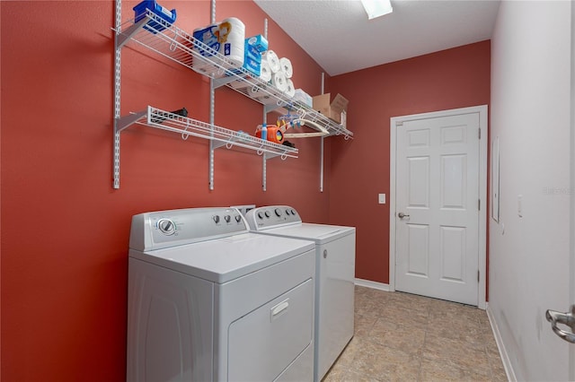 laundry area with baseboards, independent washer and dryer, and laundry area