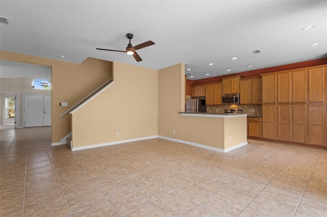 5412 72nd Ter E, Ellenton, FL 34222 - kitchen with appliances with stainless steel finishes, light tile patterned floors, brown cabinetry, backsplash, and a ceiling fan