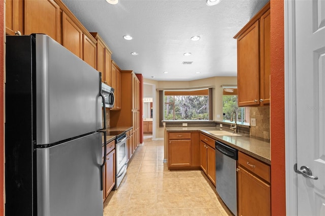 5412 72nd Ter E, Ellenton, FL 34222 - kitchen with appliances with stainless steel finishes, a sink, brown cabinets, and recessed lighting