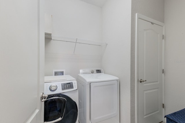 washroom featuring independent washer and dryer and laundry area