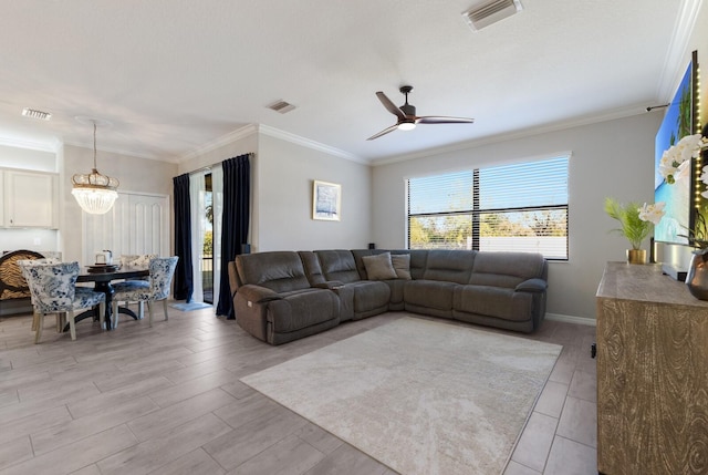 living area featuring visible vents, ceiling fan with notable chandelier, light wood-style floors, and ornamental molding