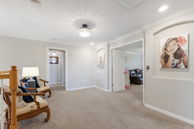 sitting room with recessed lighting, baseboards, light colored carpet, and ornamental molding