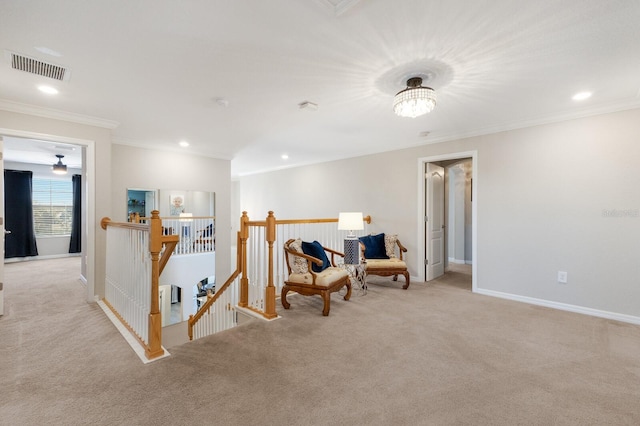 sitting room with crown molding, an upstairs landing, visible vents, and carpet floors