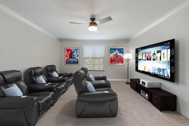 home theater room featuring light colored carpet, a textured ceiling, ceiling fan, and ornamental molding