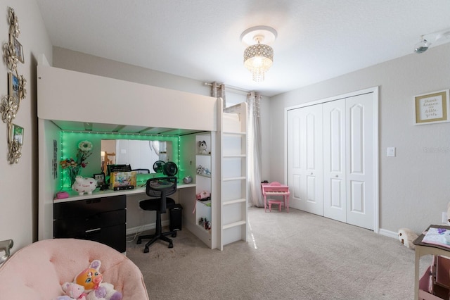 bedroom featuring carpet, a closet, and baseboards