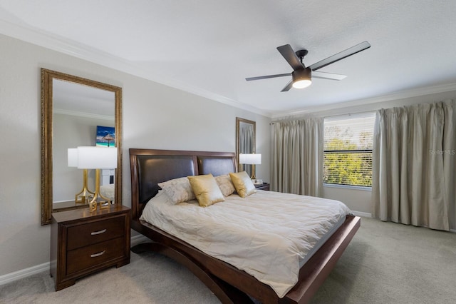 bedroom featuring crown molding, a ceiling fan, baseboards, and light carpet