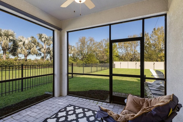 sunroom / solarium with a ceiling fan