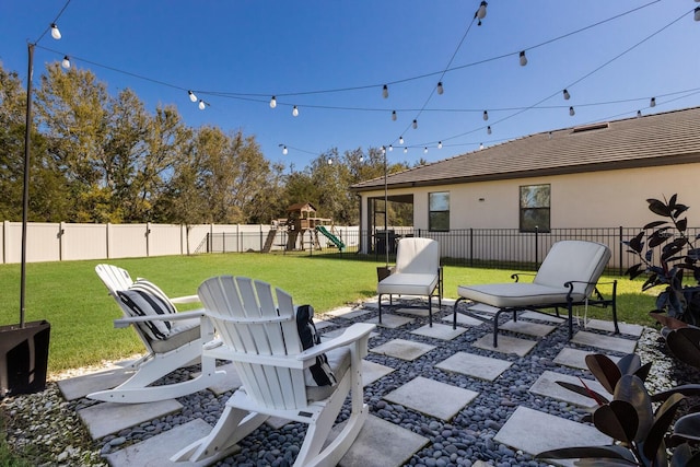 view of patio with a fenced backyard and a playground