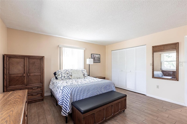 bedroom with a closet, baseboards, and wood finished floors