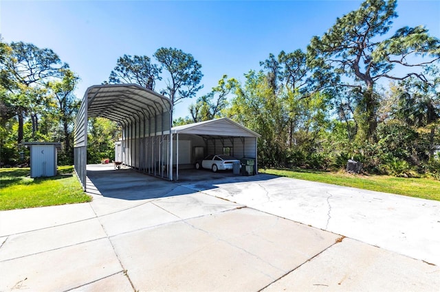 view of vehicle parking featuring a detached carport and concrete driveway