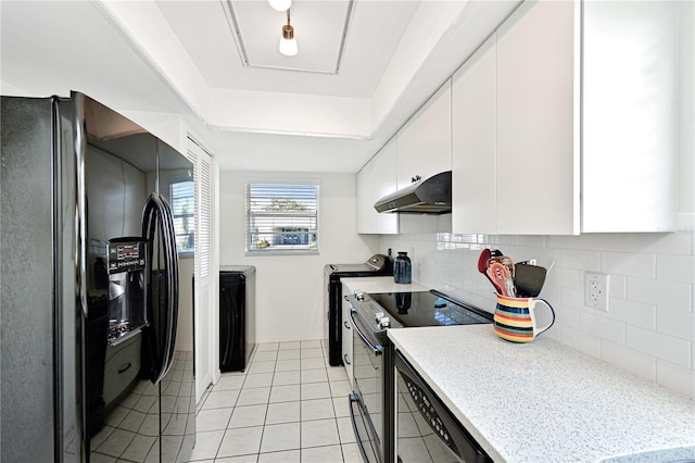 kitchen with under cabinet range hood, light tile patterned floors, decorative backsplash, white cabinets, and black appliances