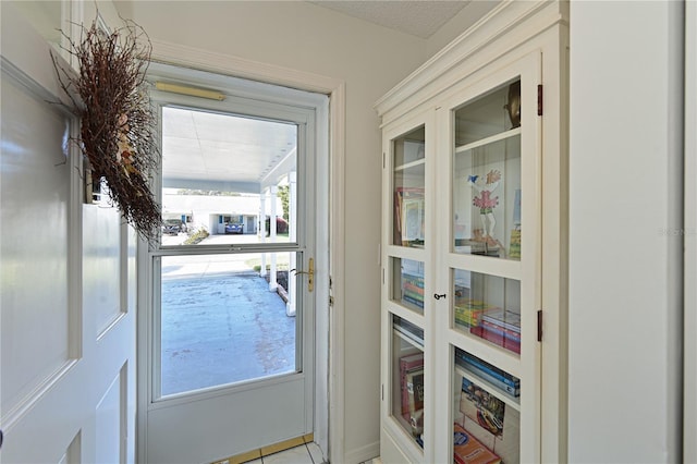 doorway featuring a textured ceiling