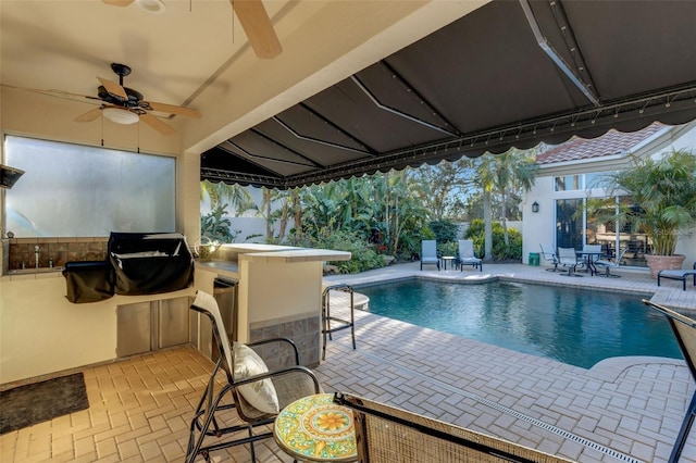 view of swimming pool featuring a fenced in pool, area for grilling, and a patio area